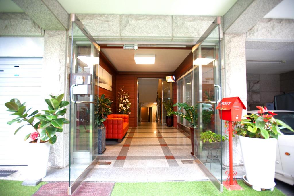 a hallway in a building with potted plants at Ryu Guest House Gangnam in Seoul