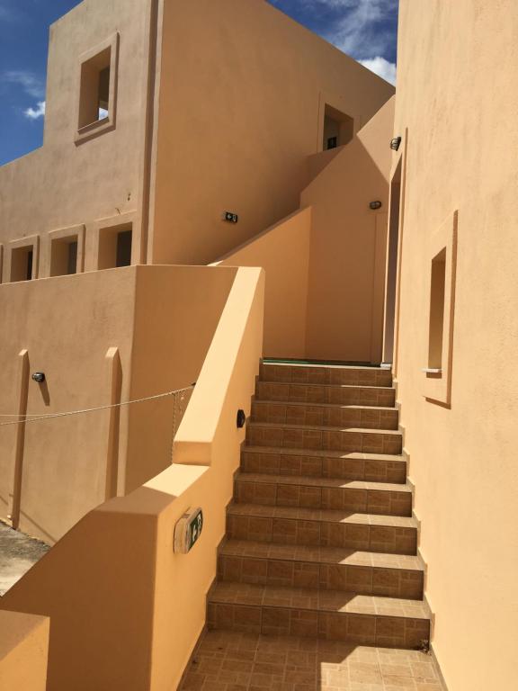 a set of stairs leading up to a building at Eugenia travasarou sea view appartments in Diakofti