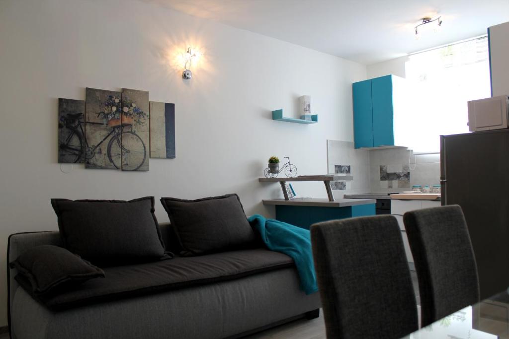a living room with a couch and a bike on the wall at Apartment Kala in Kaštela