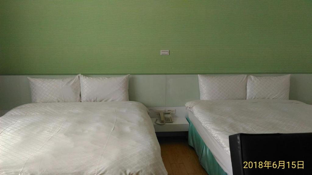 Postel nebo postele na pokoji v ubytování SKY square Homestay