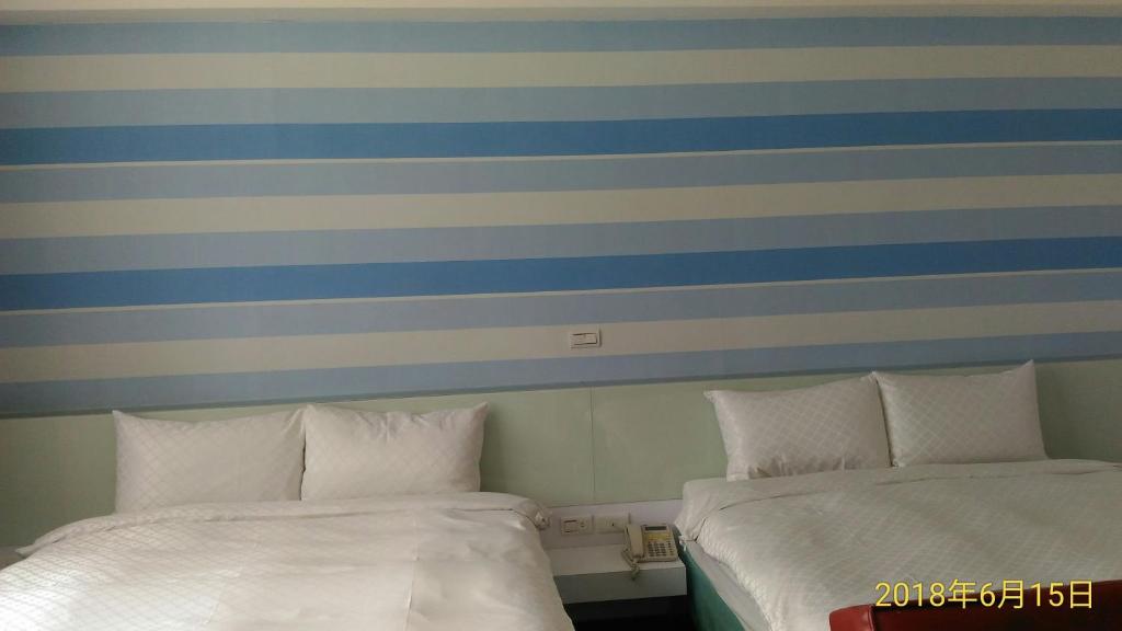 Postel nebo postele na pokoji v ubytování SKY square Homestay