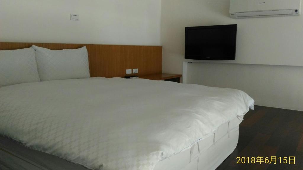 Postel nebo postele na pokoji v ubytování SKY square Homestay
