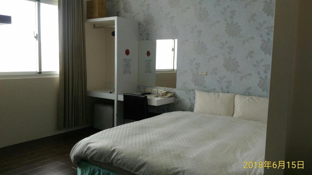 Postel nebo postele na pokoji v ubytování SKY square Homestay
