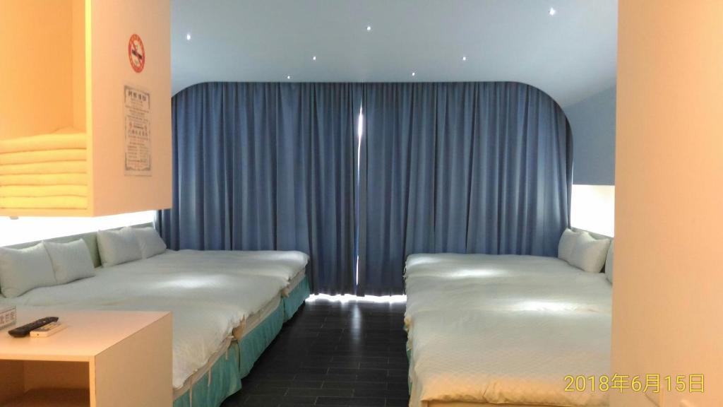 Postel nebo postele na pokoji v ubytování SKY square Homestay