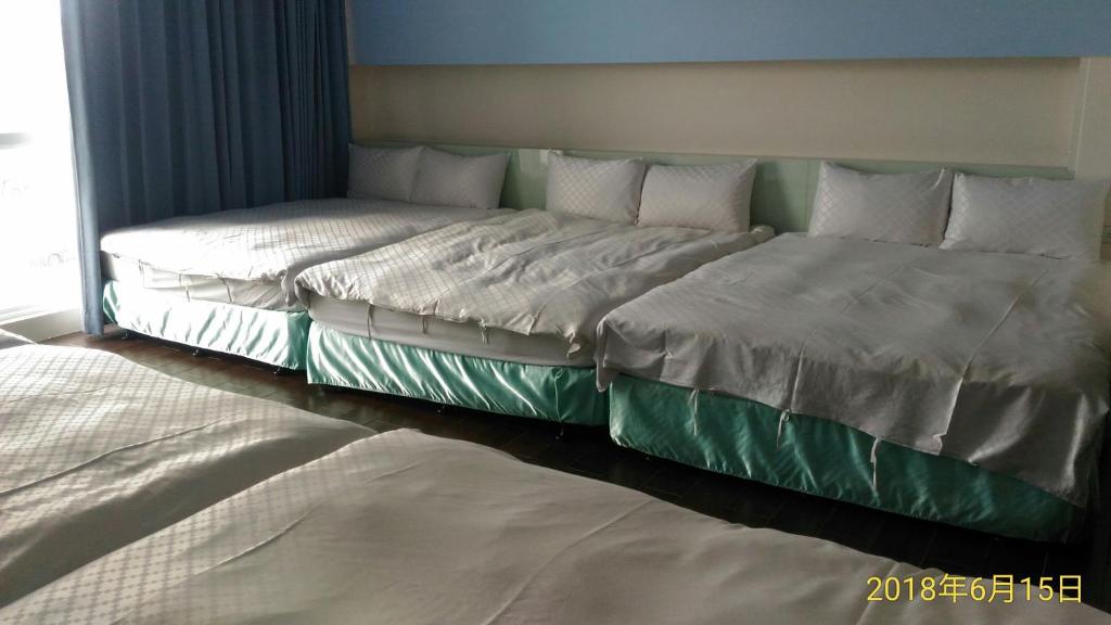 Postel nebo postele na pokoji v ubytování SKY square Homestay