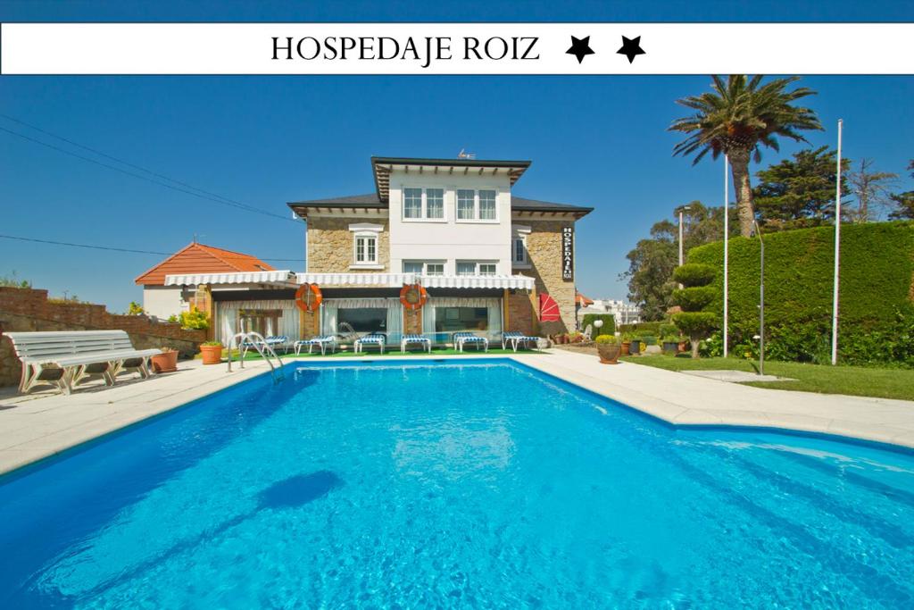 a large swimming pool in front of a house at Hospedaje Roiz in Suances