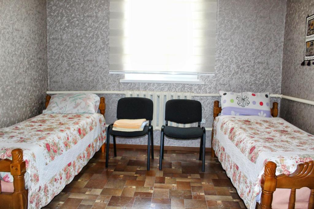 Postel nebo postele na pokoji v ubytování Tian-Shan Guest House