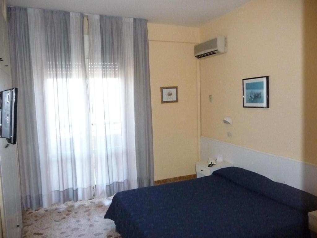 Postel nebo postele na pokoji v ubytování Hotel David