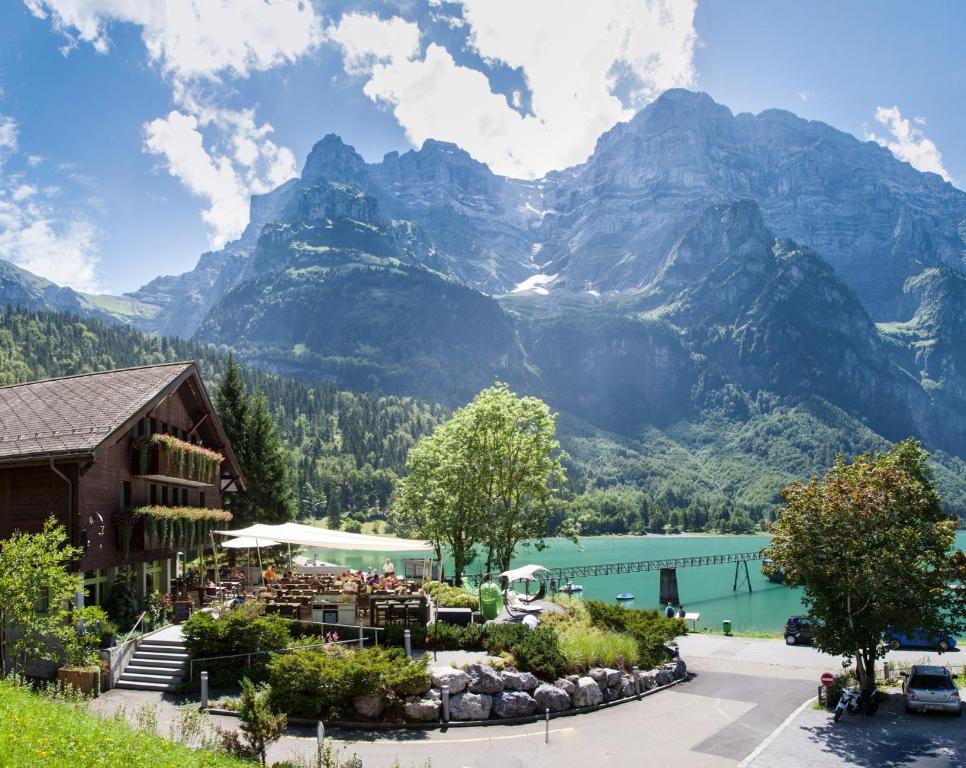 a hotel with a view of mountains and a lake at Hotel Rhodannenberg AG in Glarus