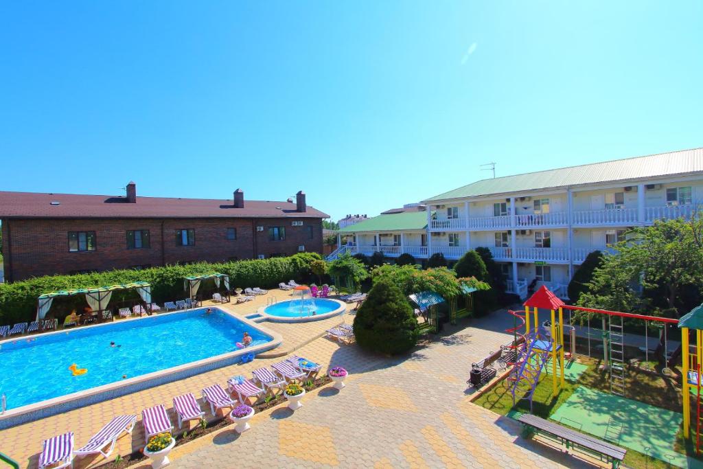 a hotel with a swimming pool and a resort at Пансионат Русич in Anapa
