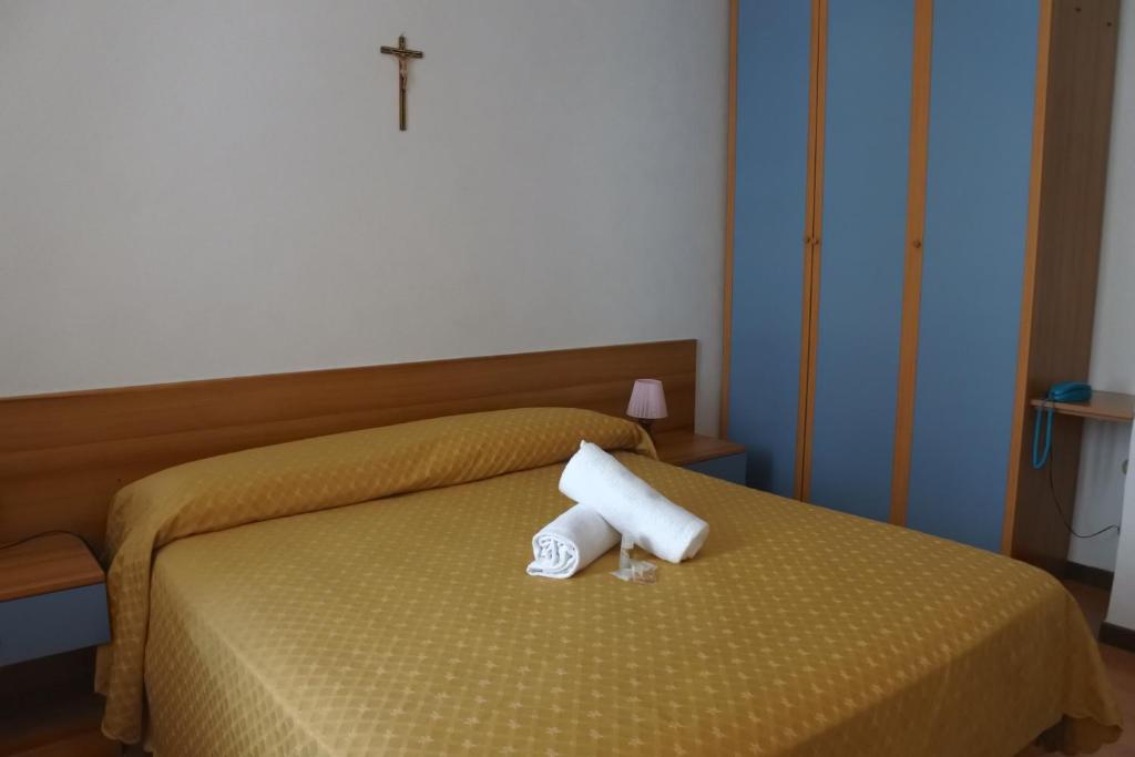 Postel nebo postele na pokoji v ubytování Hotel Loreto