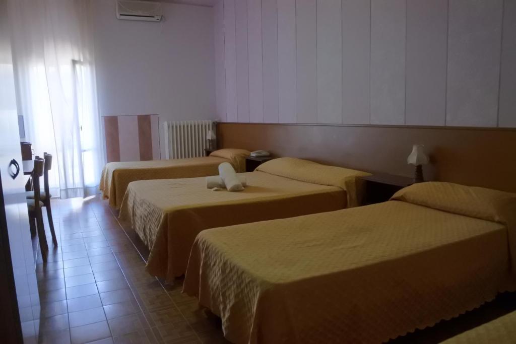 Postel nebo postele na pokoji v ubytování Hotel Loreto