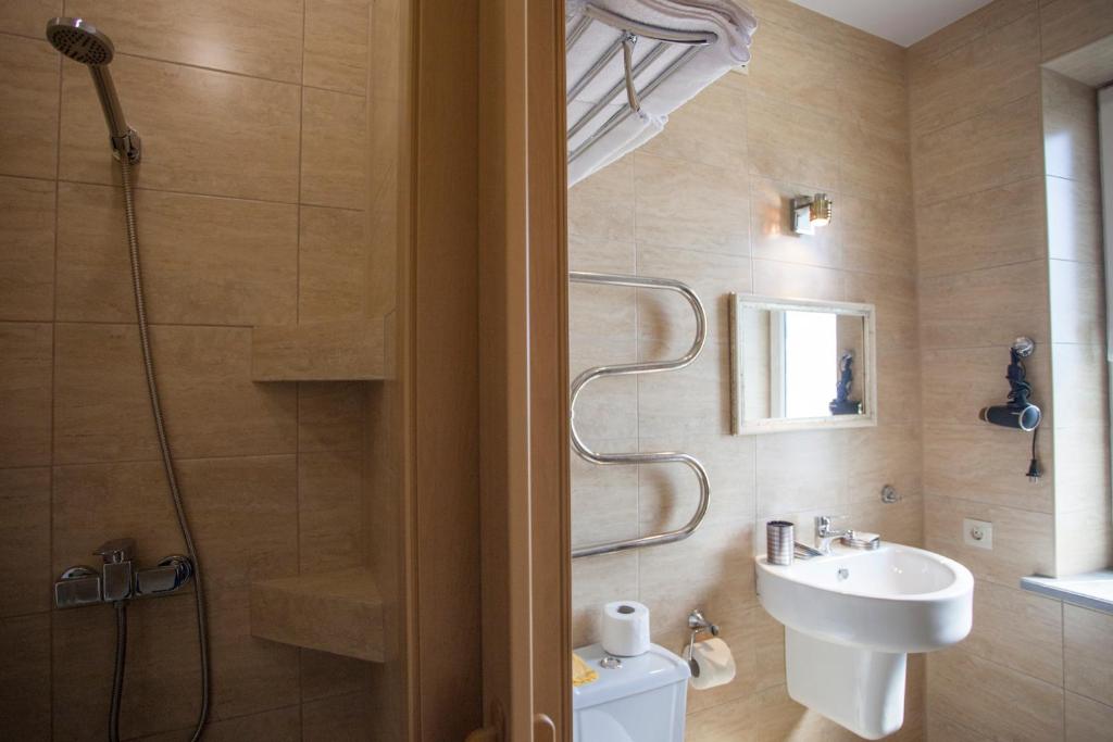 a bathroom with a shower and a sink and a toilet at Панама in Lazarevskoye
