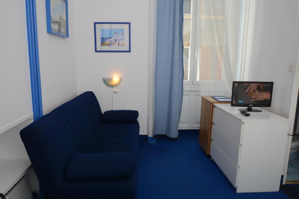 TV a/nebo společenská místnost v ubytování Olympia Hotel