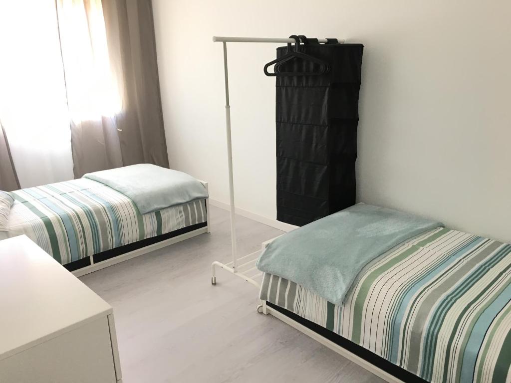 a bedroom with two twin beds and a mirror at JP House in Figueira da Foz