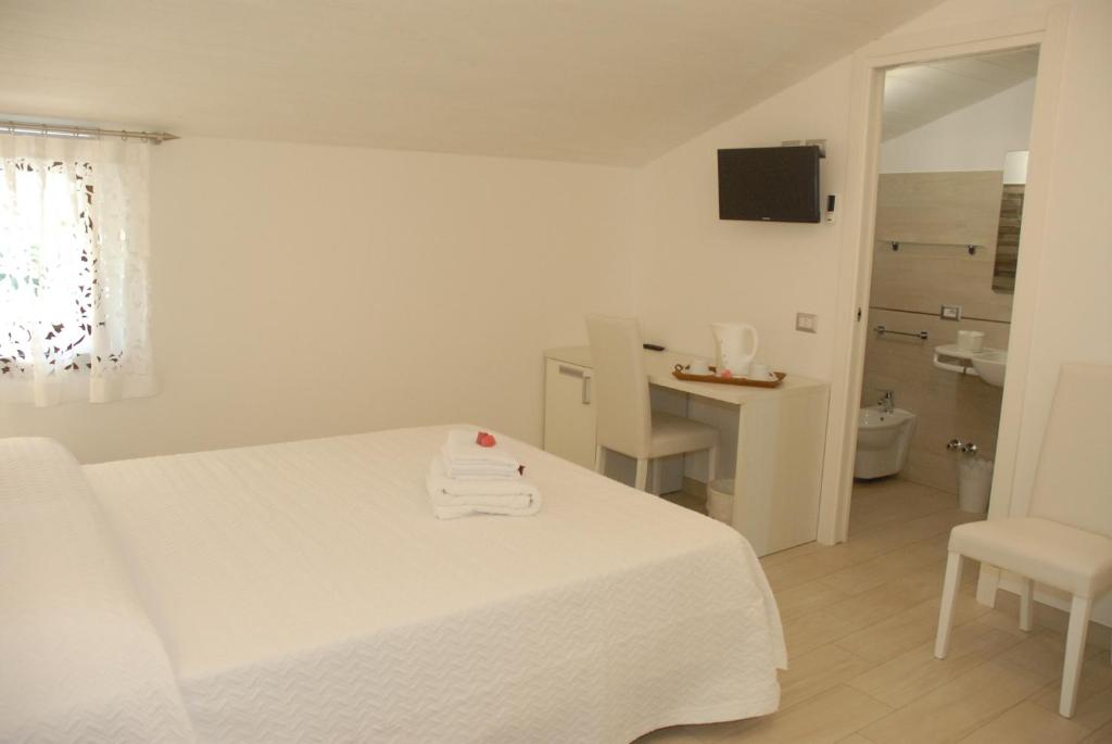 Łóżko lub łóżka w pokoju w obiekcie B&B Nonna Pina