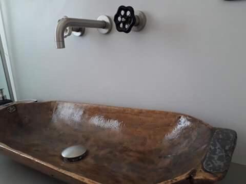a wooden sink with a faucet in a bathroom at Spitaki Serifos Studio in Rámos