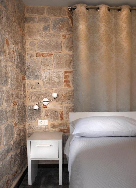 Postel nebo postele na pokoji v ubytování Elegant Residence Rooms & Apartments
