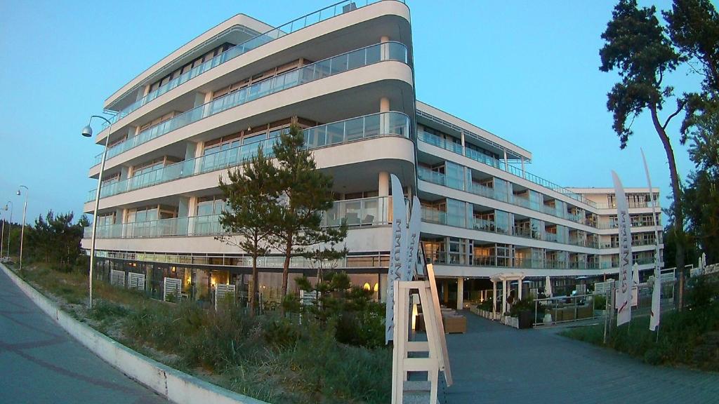a tall building with a ladder in front of it at DUNE Apartments in Mielno
