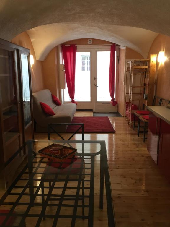 a living room with a couch and a table at Au "Gargouillard" de la citadelle Vauban in Briançon