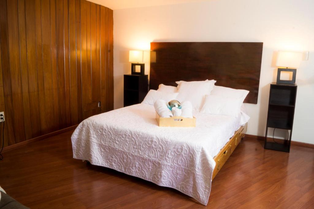 a bedroom with a bed with two stuffed animals on it at Suite 1C, Balcon, Garden House, Welcome to San Angel in Mexico City