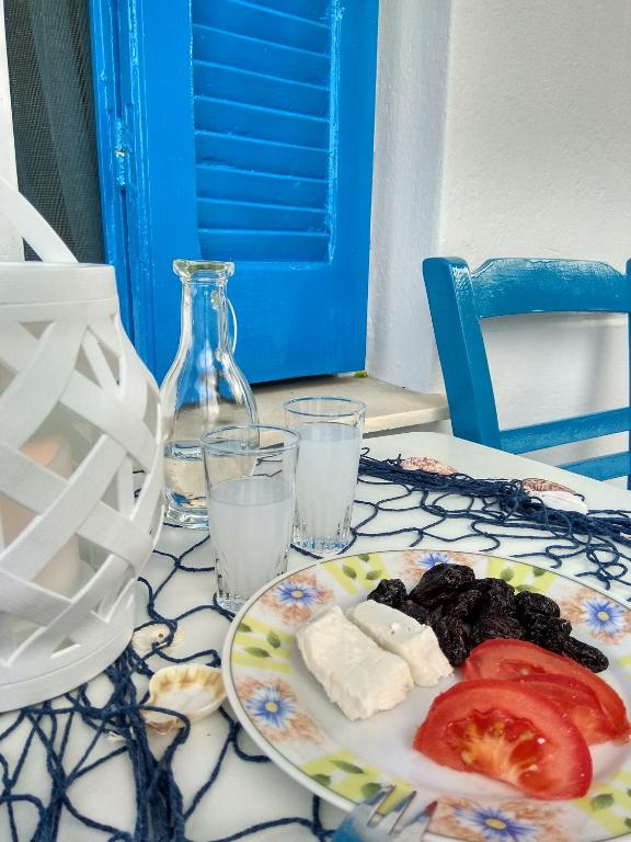 a plate of food with cheese and tomatoes on a table at Skiron House in Skala Kallirachis