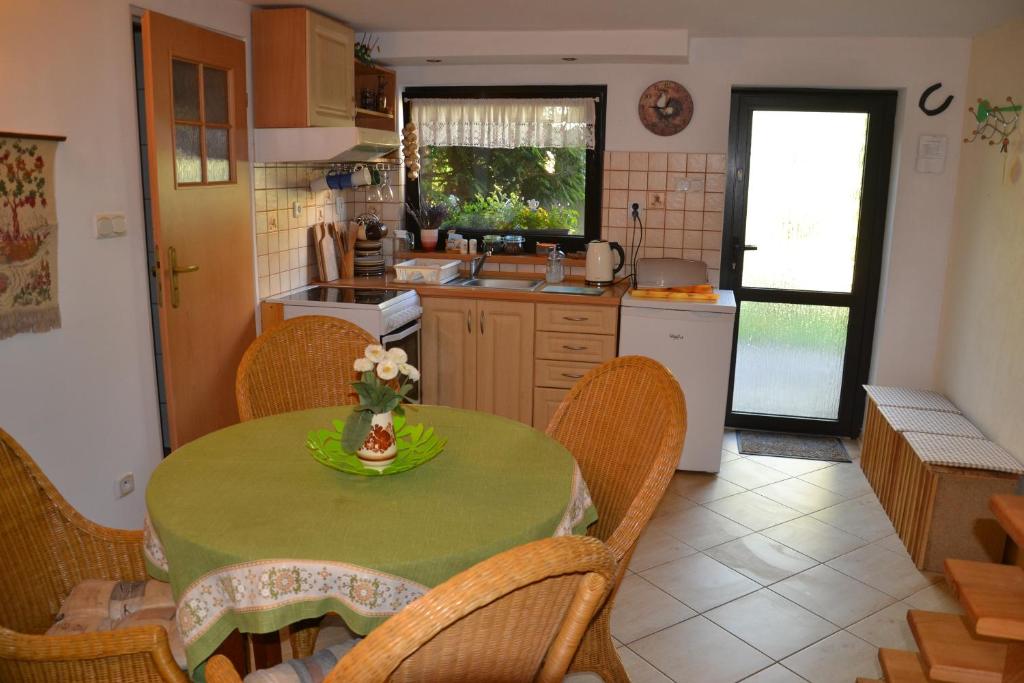 a kitchen with a table and chairs and a kitchen with a sink at Apartament nad Jeziorem Necko in Augustów