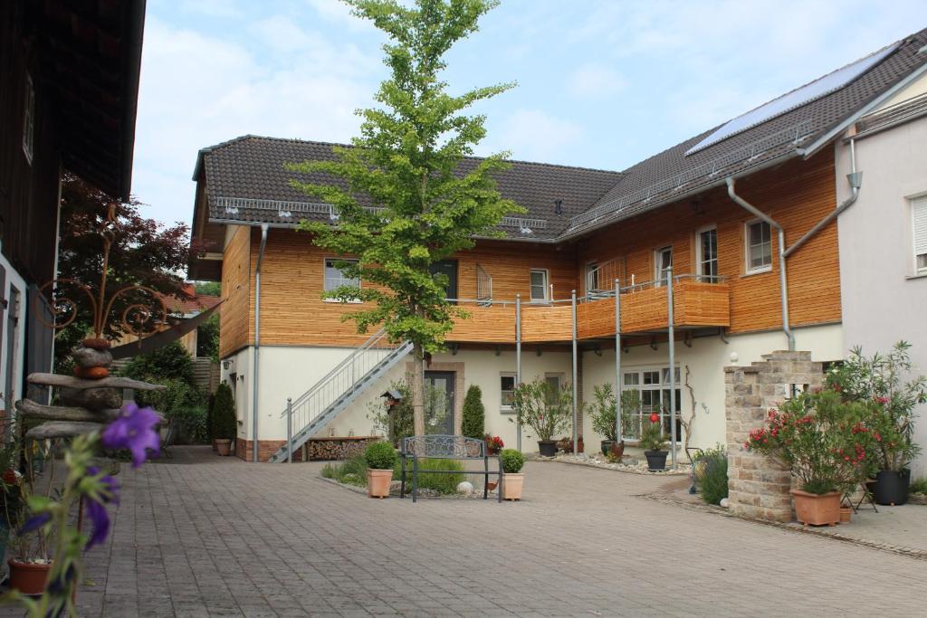 a building with a tree in the middle of a street at Zum Stadlbauern in Triftern