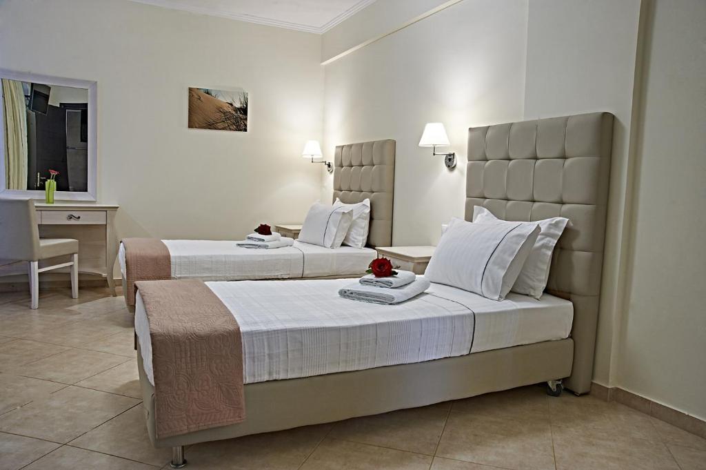 a hotel room with two beds and a desk at Element Hotel in Elafonisos