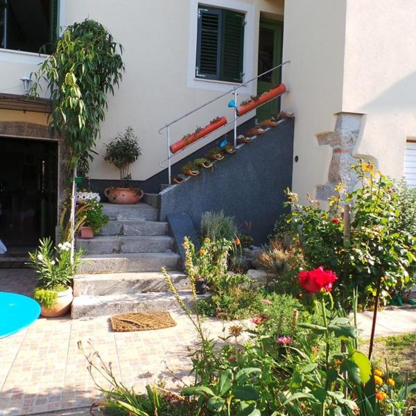 ein Haus mit einem Garten mit Blumen und Treppen in der Unterkunft Jankoviceva cesta 19 in Matulji