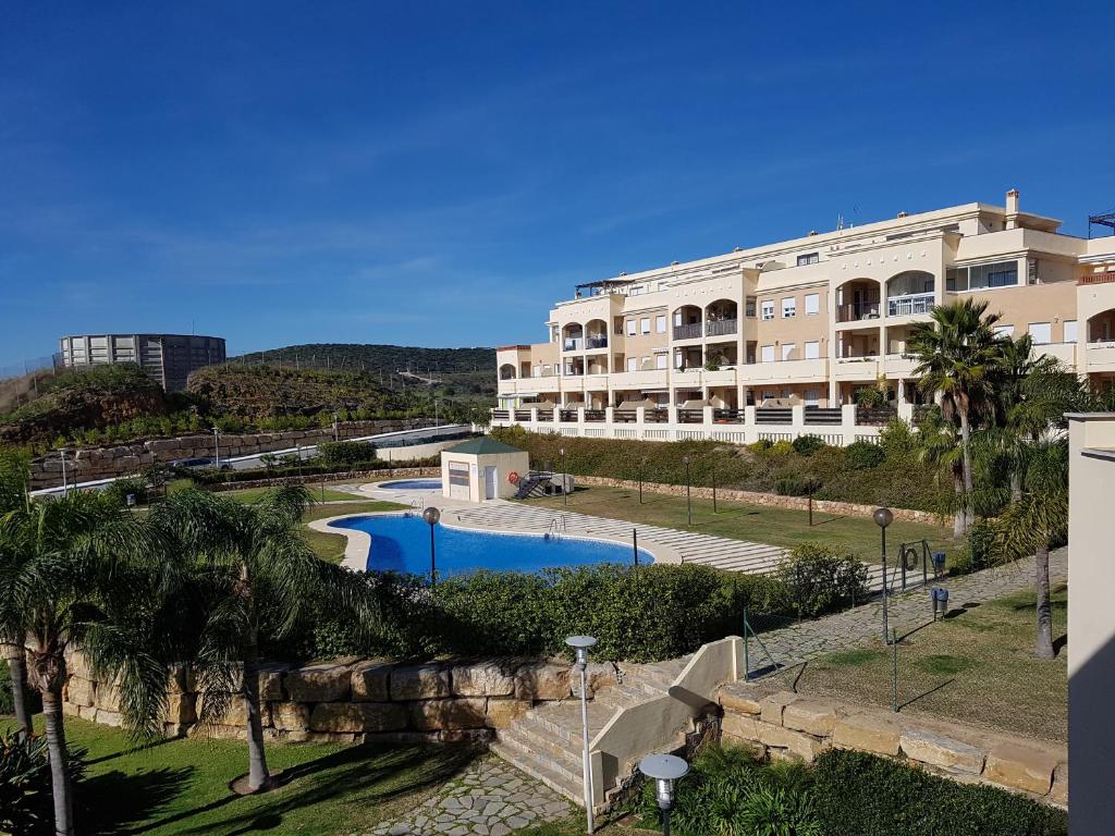 a large building with a swimming pool in front of it at Residential ALAZAN in Mijas Costa