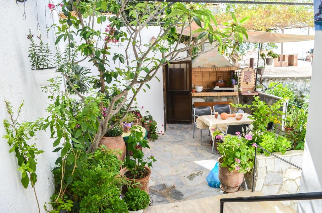 a patio with potted plants and a table at Kalypso in Agia Galini