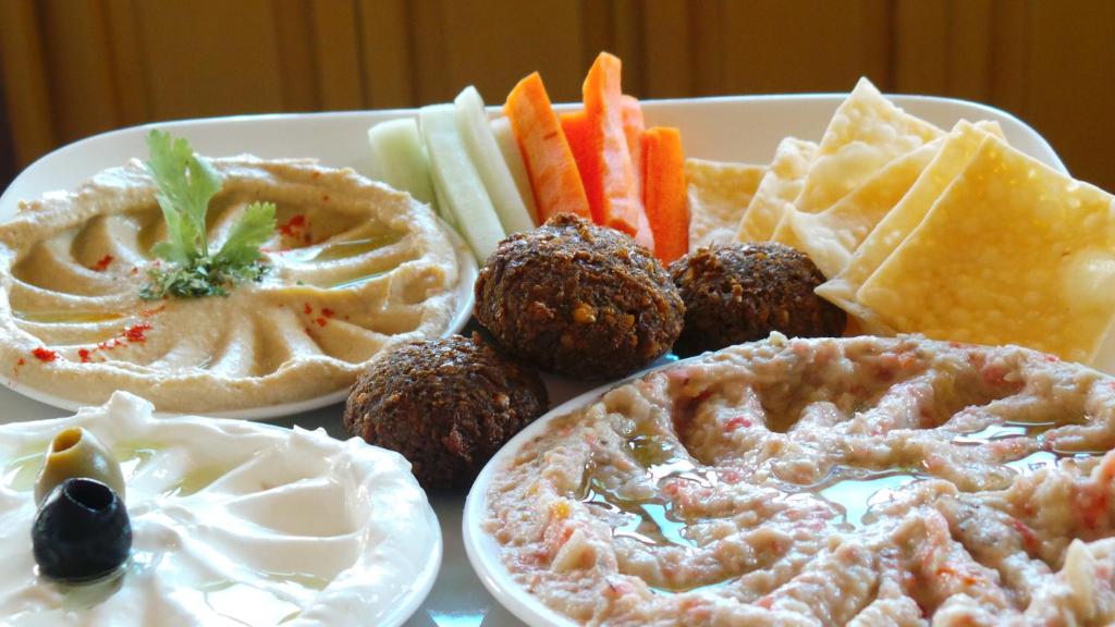 a plate of food with different types of food at Hotel Surya, Kaiser Palace in Varanasi