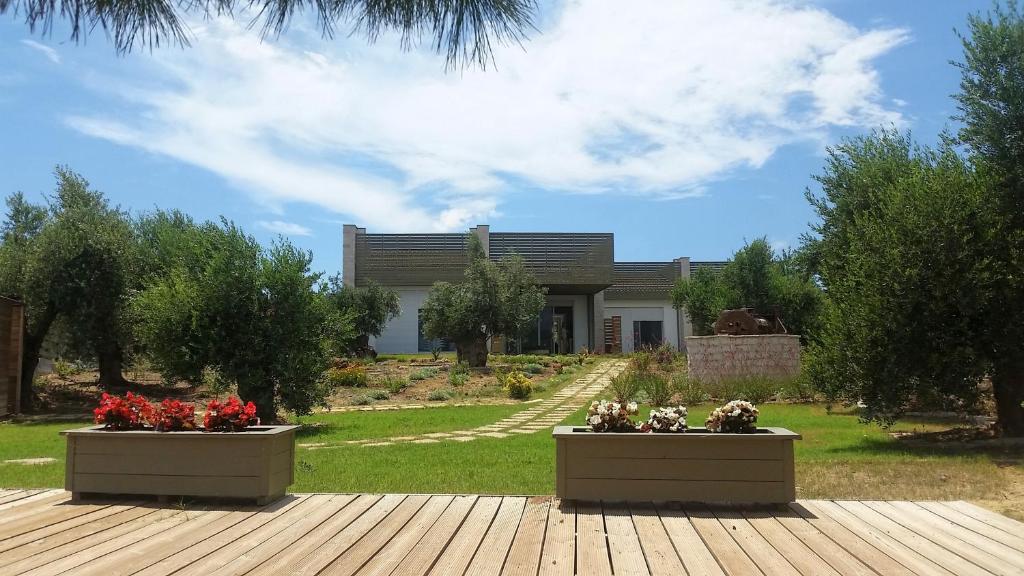 a house with two flower pots in front of it at Meli Seaside Villas in Khránoi