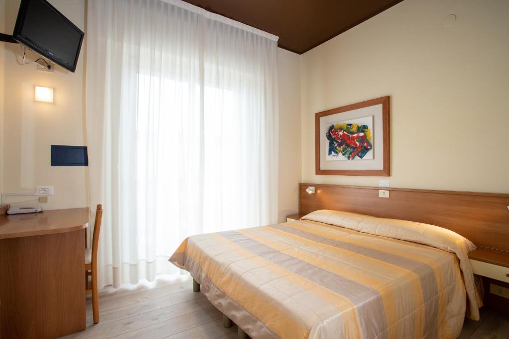 Postel nebo postele na pokoji v ubytování Hotel Ancora