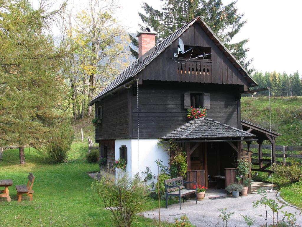 a black and white house with a porch at Ferienhaus "Badl" in Bad Goisern