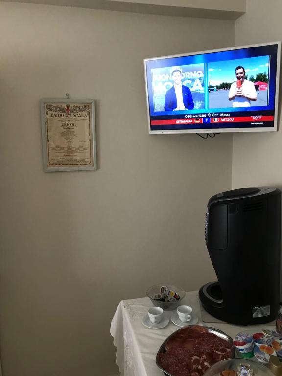 TV a/nebo společenská místnost v ubytování L’OPERÀ