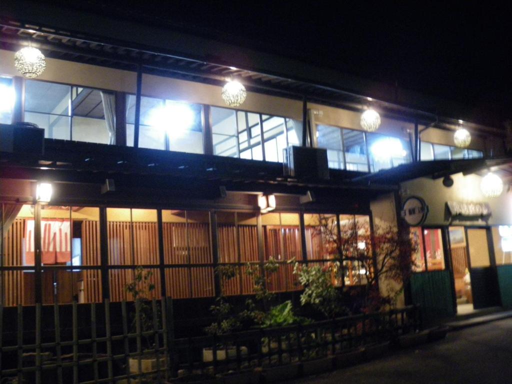 a building with a balcony at night with lights at Yamanokami Onsen in Nagano