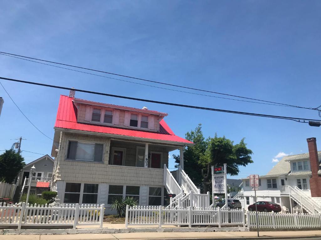 a house with a red roof on a street at Mallard Apartments in Ocean City