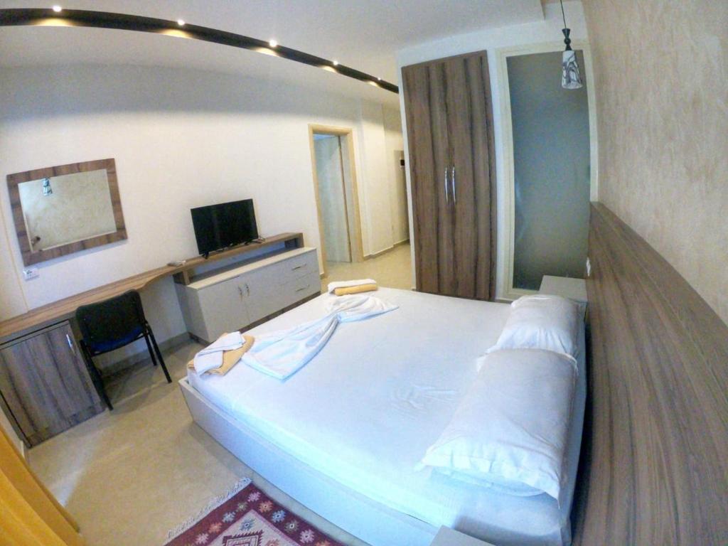 A bed or beds in a room at Hotel Kamomil