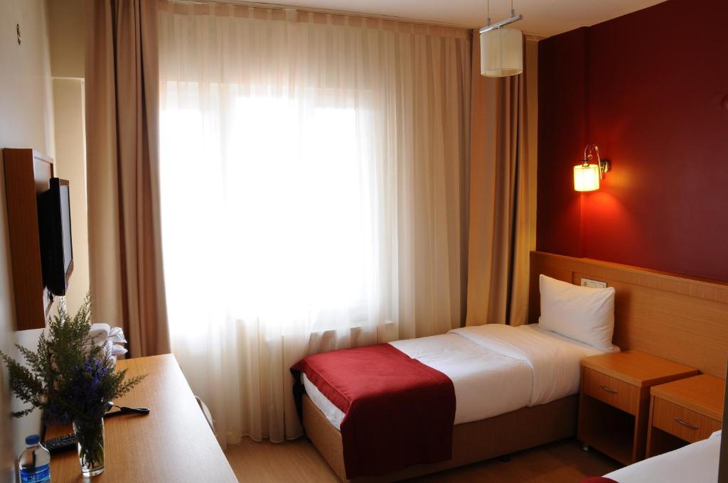 Ένα ή περισσότερα κρεβάτια σε δωμάτιο στο Cetinkaya Hotel