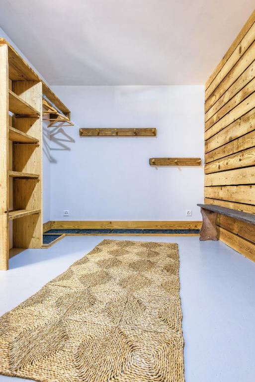 a room with wooden walls and a rug at Chalet le Petou in Champéry