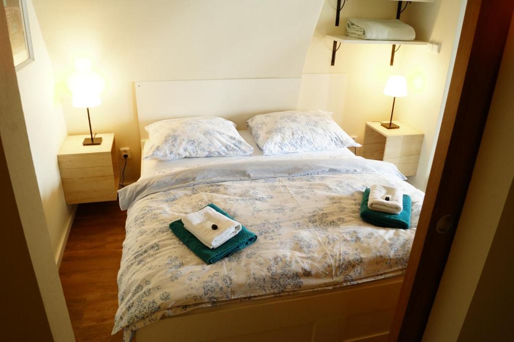 a bedroom with two beds with towels on it at Apartmány u komína in Terezín