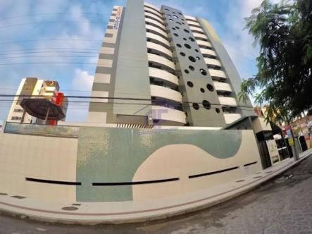 a large building with a painting on the side of it at Apartamento Edf Green Tower in Maceió