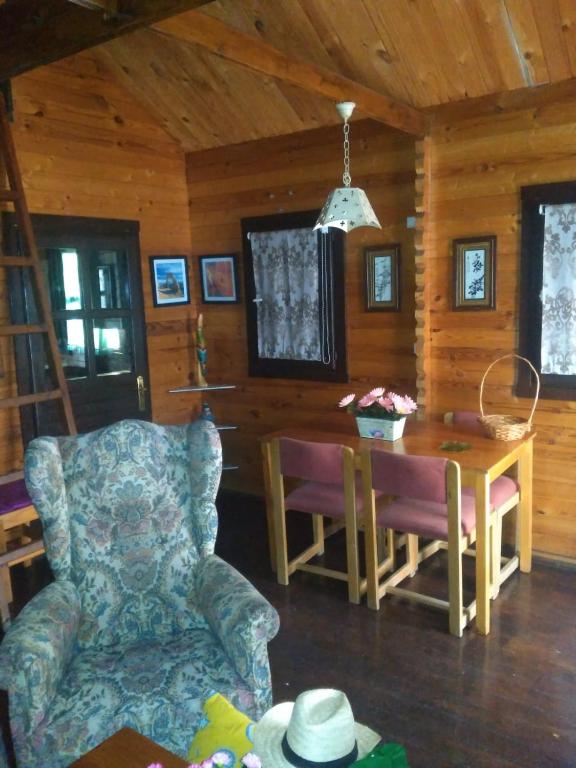 a living room with a table and a chair at El mirador del consuelo in Jorquera