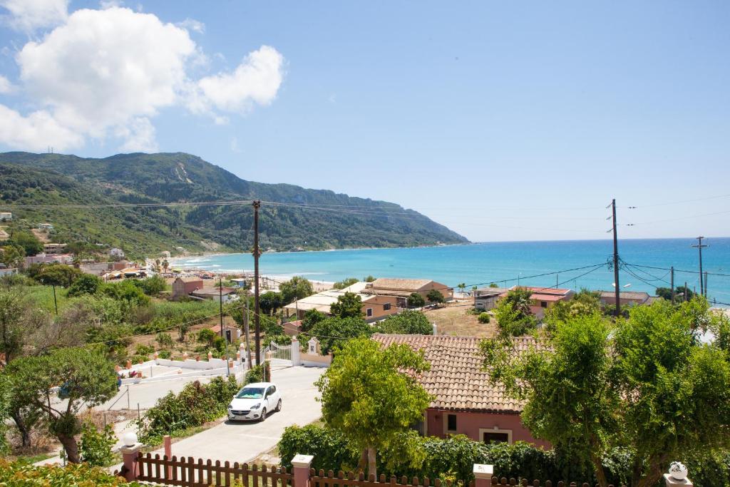 a view of a town with the ocean in the background at Eleana apartments and studios in Agios Georgios Pagon
