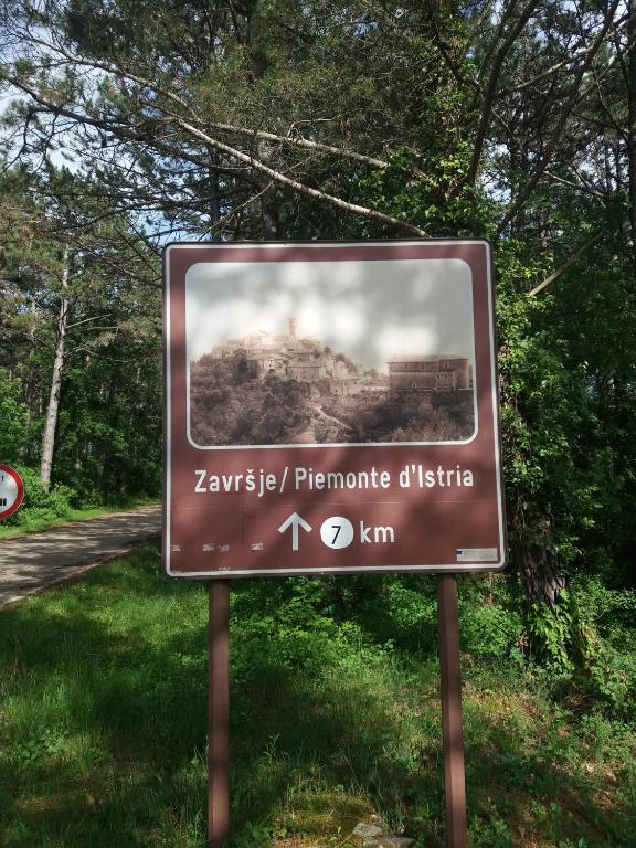 a brown sign with a picture of a train at Villa Malini in Grožnjan