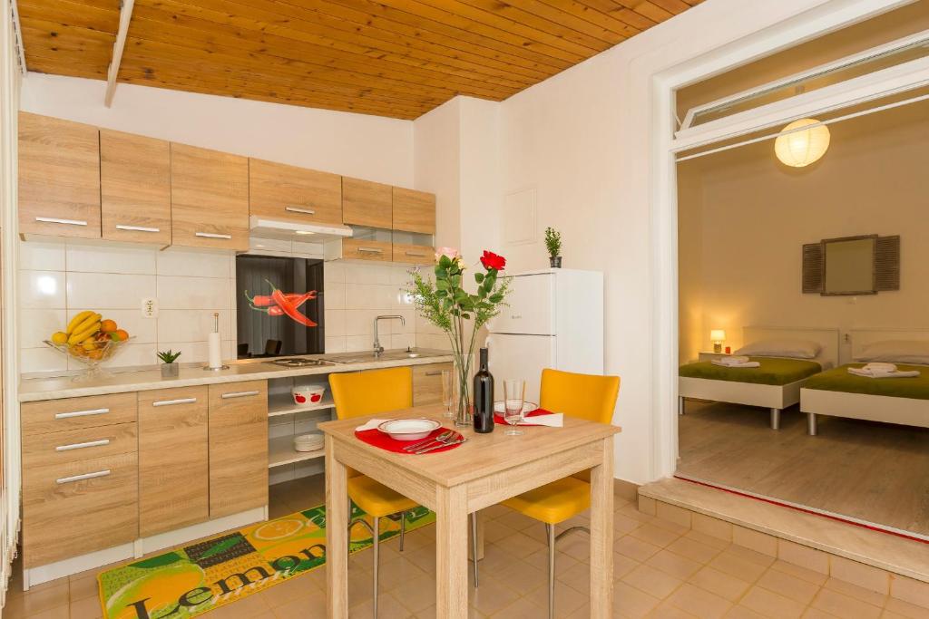 - une cuisine avec une table et des chaises en bois dans la chambre dans l'établissement Studio Leon-Sara, à Split