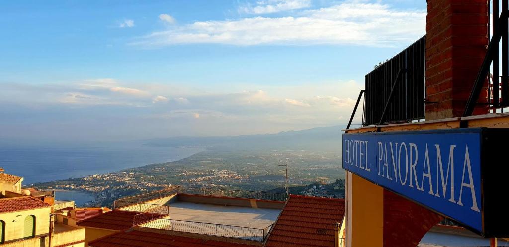 a blue street sign on the side of a building at Hotel Panorama di Sicilia in Castelmola