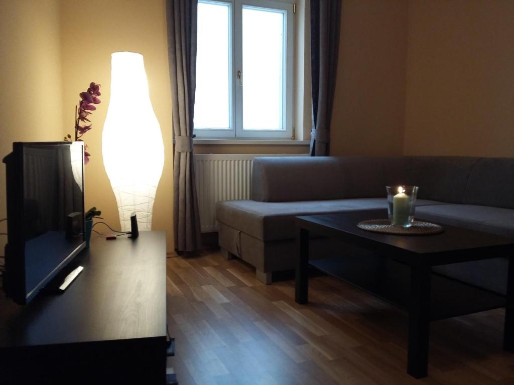 salon z kanapą, stołem i telewizorem w obiekcie Angel apartment nr 4 near to the center w Pradze